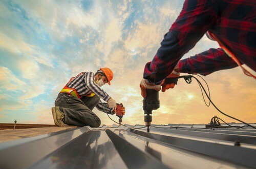 Roofer Working On Iron Roof